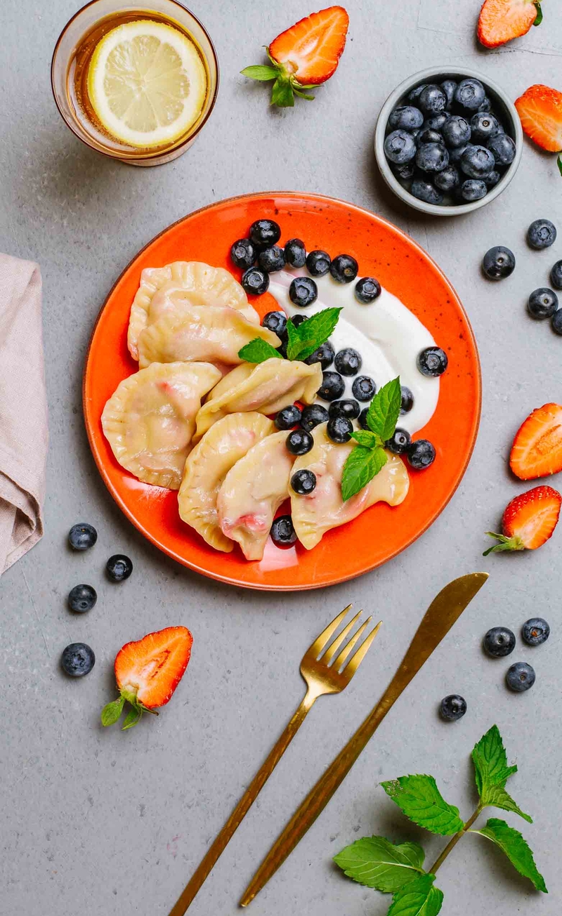 Pierogi z truskawkami, bita śmietana, borówki