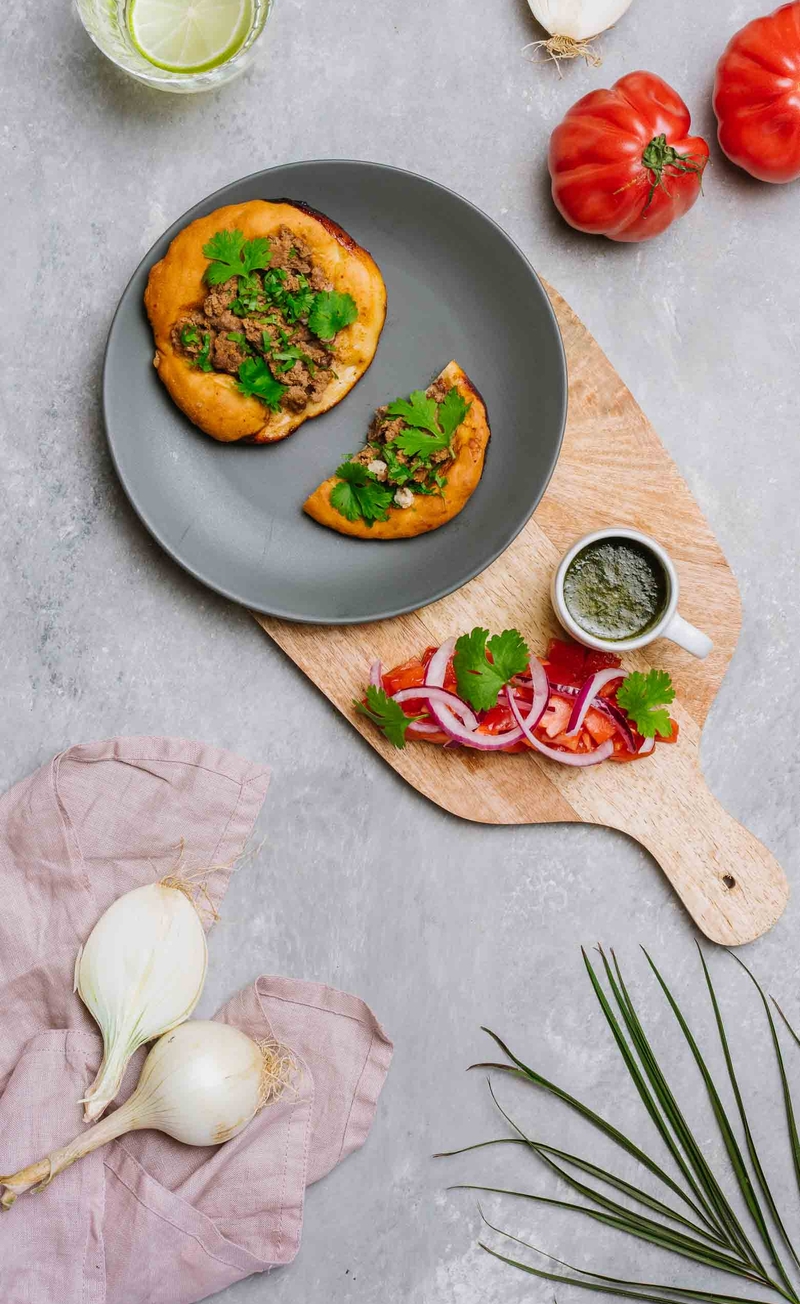 Arabska pizza z mięsem jagnięco-wołowym i kolendrą, sałatka z pomidorem malinowym i czerwoną cebulą, sos miętowy