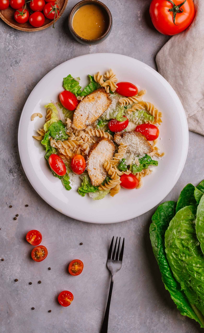 Sałatka z makaronem proteinowym, kurczakiem, parmezanem, pomidorkami i sałatą rzymską, italian dressing