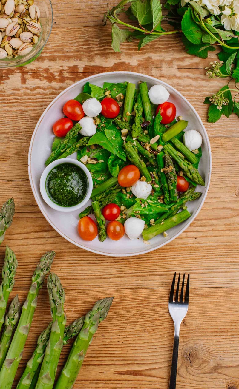 Szparagi a'la caprese z mini mozzarellą, pomidorkami, sałatą rzymską i kruszonymi pistacjami, pesto bazyliowe
