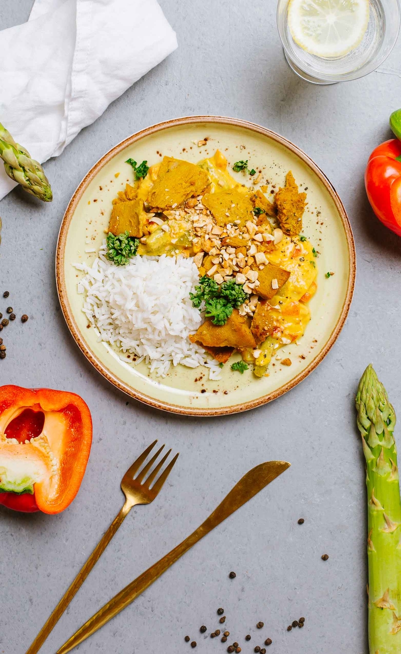 Czerwone curry z wegańskim kurczakiem, szparagami i czerwoną papryką, ryż basmati z prażonymi nerkowcami